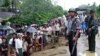 A Myanmar policeman and soldier provide security