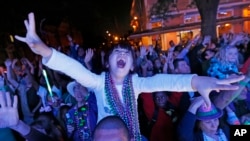FILE - A young reveler scream for beads during the Krewe of Endymion Mardi Gras parade in New Orleans, Saturday, Feb. 25, 2017. (AP Photo/Gerald Herbert)