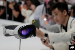FILE - The Apple Vision Pro headset is displayed in a showroom on the Apple campus in Cupertino, Calif., after its introduction at the company's annual developers conference on June 5, 2023. (AP Photo/Jeff Chiu, File)