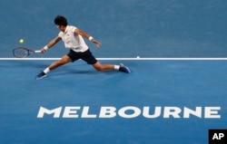 South Korea's Chung Hyeon makes a backhand return to Serbia's Novak Djokovic