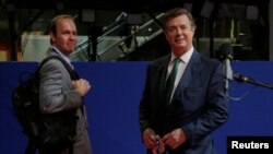 FILE - Paul Manafort, right, campaign manager to Republican Presidential Candidate Donald Trump, and his assistant Rick Gates stand on the floor of the Republican National Convention in Cleveland, July 17, 2016.