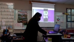 Wylona Rogers teaches students attending a class in-person as well as students attending virtually at Driggers Elementary School, Monday, Feb. 8, 2021, in San Antonio. After seeing two academic years thrown off course by the pandemic, school leaders around the country are planning for the possibility of more distance learning next fall at the start of yet another school year. (AP Photo/Eric Gay)