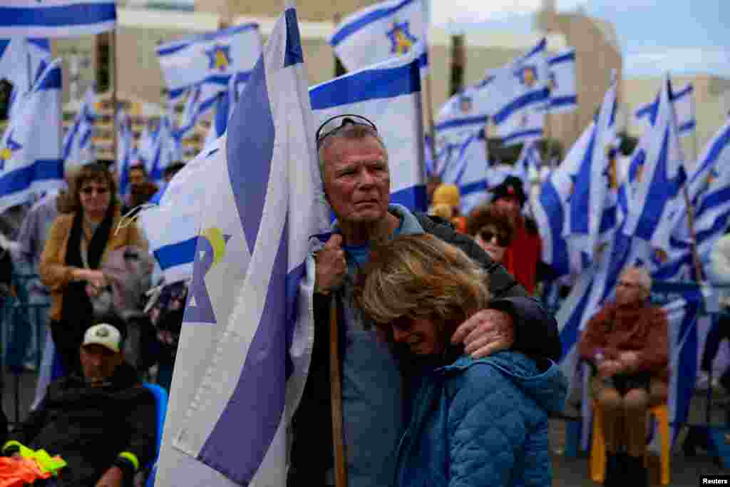 People gather, on the day the bodies of deceased Israeli hostages, Oded Lifschitz, Shiri Bibas and her two children Kfir and Ariel Bibas, who were kidnapped during the deadly October 7, 2023 attack by Hamas, are handed over under the terms of a ceasefire between Hamas and Israel, in Tel Aviv, Israel. REUTERS/Ammar Awad