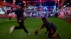 American football fans attempt a field goal at the NFL Experience, a fan festival in Houston, Texas leading up to the Super Bowl on Sunday, February 5th. (B. Allen/VOA)