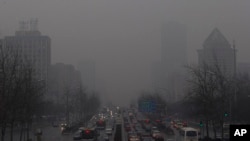 1月31日拥挤在雾霾笼罩下的北京一条要道上爬行的车辆