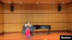 Nina Huang plays the flute at a charity concert at Santa Clara University?s recital hall in Santa Clara, California, U.S., in this April 2022 handout photo. (Xia Liu/Handout)