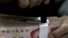 一名銀行職員整理人民幣(資料圖片)