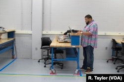 FILE: Manufacturing worker Marcus Odoms graduated from Northwest State Community College’s Industrial Automation Certificate Program in Ohio. He says it will mean less pain for his body and more take-home pay for his family.