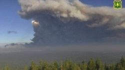 In this Tuesday, Aug. 17, 2021 file image from a U.S. Forest Service wildfire monitoring camera, plumes of smoke rise from the Caldor Fire in El Dorado County, Calif. (U.S. Forest Service/ALERTWildfire Network via AP, File)