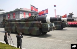 FILE - In this April 15, 2017, file photo, what analysts believe could be the North Korean Hwasong 12 is paraded across Kim Il Sung Square during a military parade in Pyongyang, North Korea. (AP Photo/Wong Maye-E, File)