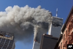 In this Sept. 11, 2001 file photo, smoke rising from the burning twin towers of the World Trade Center after hijacked planes crashed into the towers, in New York City.