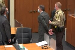 Former Minneapolis police officer Derek Chauvin is led away in handcuffs after a jury found him guilty of all charges in his trial for murder in the death of George Floyd in Minneapolis, Minnesota, April 20, 2021.