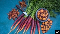 This image provided by Baker Creek Heirloom Seed Co. shows Lila Lu Sang carrots, which are deep purple on the outside and bright orange on the inside. (Baker Creek Heirloom Seed Co./rareseeds.com via AP)