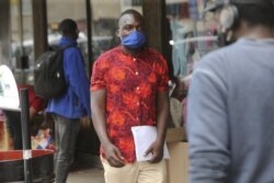 Emmanuel Reyai walks on the streets of Harare while looking for a job, Wednesday, Aug, 5, 2020.