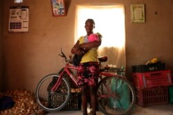 Virginia Mavhunga, a 13-year-old teenage mother, hold her child , Saturday, Dec. 11, 2021.(AP Photo/Tsvangirayi Mukwazhi)