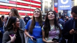 Employees of Coinbase Global Inc, the biggest U.S. cryptocurrency exchange, watch as their listing is displayed on the Nasdaq MarketSite jumbotron at Times Square in New York, U.S., April 14, 2021. REUTERS/Shannon Stapleton