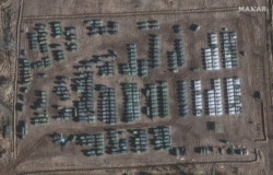 This handout satellite image taken Nov. 1, 2021, and released by Maxar Technologies shows the presence of a large ground force deployment near Yelnya, Smolensk region, Russia, about 260 kilometers (160 miles) north of the Ukrainian border.