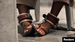 FILE - A detainee's feet are seen shackled to the floor inside the Camp 6 high-security detention facility at Guantanamo Bay U.S. Naval Base April 27, 2010.