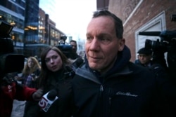 Harvard University professor Charles Lieber is surrounded by reporters as he leaves the Moakley Federal Courthouse in Boston, Jan. 30, 2020.