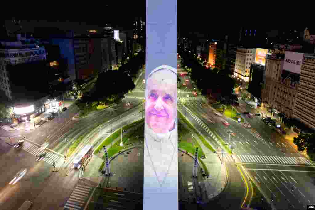 An aerial view shows the Obelisk illuminated with the image of Pope Francis as he recovers in hospital, in Buenos Aires. (Photo by Luis ROBAYO / AFP)