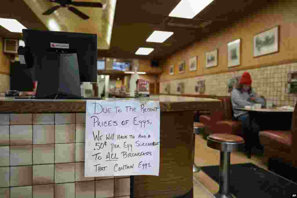 A sign is posted at the register read "Due to the recent price of eggs, we will have to add a .50 cent per egg surcharge to all breakfasts that contain eggs." at the Pepper Pod Restaurant in Newport, Kentucky.