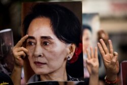 FILE - A protester holds a photo of detained Myanmar civilian leader Aung San Suu Kyi during a demonstration against the military coup outside the Myanmar Embassy in Bangkok on Feb. 7, 2021.