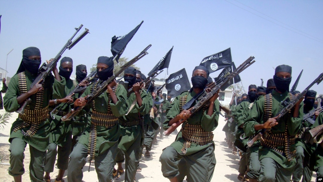 FILE - Al-Shabab fighters march with their weapons during military exercises on the outskirts of Mogadishu, Somalia, Feb. 17, 2011. 