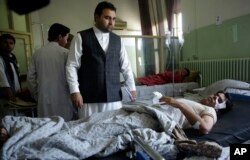 Wounded men lie on their beds in Wazir Akbar Khan Hospital in Kabul after a massive explosion.