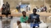 Horse cart drivers transport goods and passengers through deep flood waters in Sicap Mbao, a neighborhood on the outskirts of Dakar, Senegal, Saturday, Sept. 12, 2009