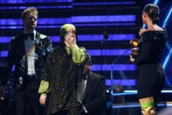 62nd Grammy Awards - Show - Los Angeles, California, U.S., January 26, 2020 - Billie Eilish, with brother and music partner Finneas O'Connell behind her, reacts to winning Record Of The Year for 'Bad Guy.' (REUTERS/Mario Anzuoni)