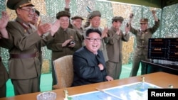 North Korean leader Kim Jong Un reacts during a test launch of ground-to-ground medium long-range ballistic rocket Hwasong-10 in this undated photo released by North Korea's Korean Central News Agency (KCNA) on June 23, 2016. 