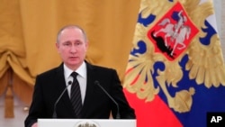 Russian President Vladimir Putin speaks during a New Year reception in the Kremlin in Moscow, Russia, Wednesday, Dec. 28, 2016. (Mikhail Klimentyev/Sputnik, Kremlin Pool Photo via AP)