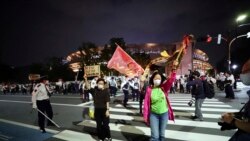 People protesting the Tokyo 2020 Olympics on May 9, 2021. (AP Photo/Eugene Hoshiko)