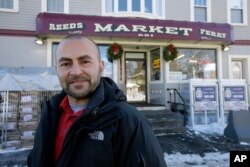 Sam Safa, of Merrimack, N.H., owner of Reeds Ferry Market, stands for a photograph outside the convenience store, Sunday, Jan. 7, 2018, in Merrimack.