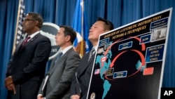 在华盛顿举行的司法部新闻发布会上，执法官员出现在一张毒品分销海报前，宣布对两名中国芬太尼追踪者提起诉讼，以打击鸦片类物质。（2017年10月17日）