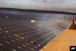 FILE - A photovoltaic solar park situated on the outskirts of the coastal town of Lamberts Bay, South Africa on March. 29, 2016. (AP Photo/Schalk van Zuydam)