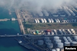 Oil and gas tanks are seen at an oil warehouse at a port in Zhuhai, China October 22, 2018. REUTERS/Aly Song