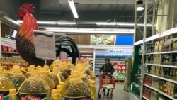 A shopper pushes a cart down a quiet Lotte Mart in Beijing, China, March 17, 2017. (AP)