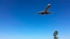 ARCHIVO - En esta fotografía del 26 de enero de 2018, la gente observa un avión de pasajeros volar sobre Gravelly Point Park cuando aterriza en el Aeropuerto Ronald Reagan National de Washington.