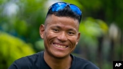 Nepali climbing guide Tenjen Sherpa, 35, poses during an interview with the Associated Press in Kathmandu, Nepal, Wednesday, August 9, 2023. (AP Photo/Niranjan Shrestha)