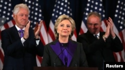 Hillary Clinton addresses her staff and supporters about the results of the U.S. election as former U.S. President Bill Clinton (L) and her running mate Tim Kaine applaud at a hotel in the Manhattan borough of New York, U.S., November 9, 2016. REUTERS/Carlos Barria 