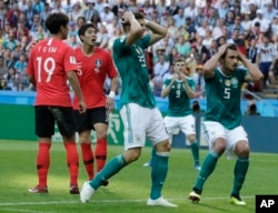 Germany's Mario Gomez, center, and Germany's Mats Hummels, right, hold their heads after failing to score during the group F match between South Korea and Germany, at the 2018 soccer World Cup in the Kazan Arena in Kazan, Russia, Wednesday, June 27, 2018.