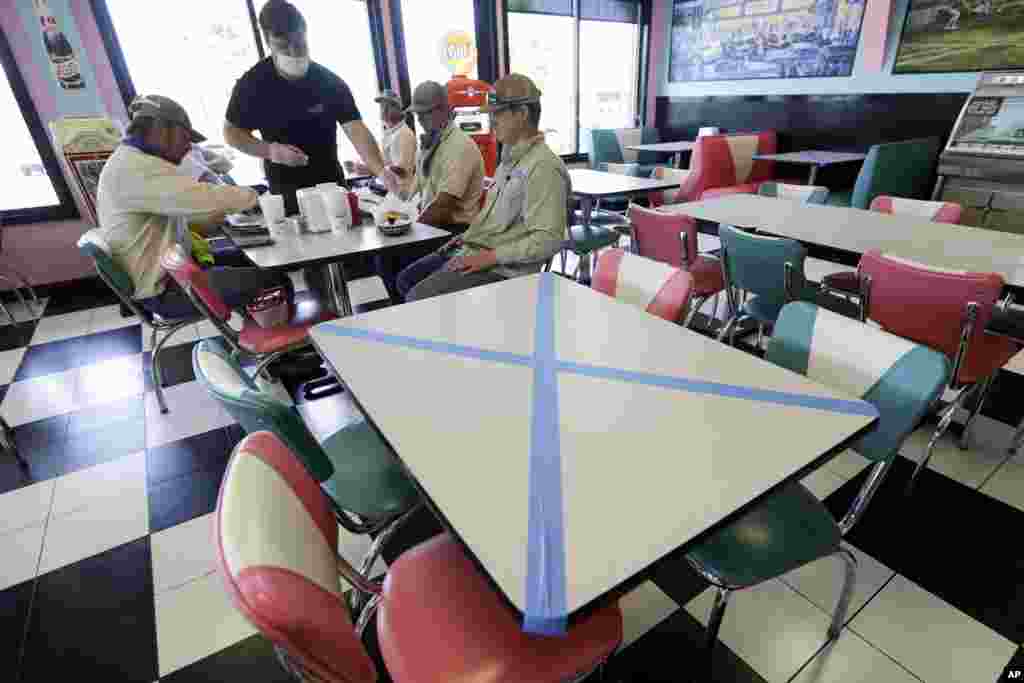 Tables are marked off for social distancing at Hwy 55 Burgers Shakes & Fries Monday, April 27, 2020, in Nolensville, Tenn. (AP Photo/Mark Humphrey)