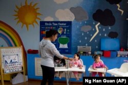 Children attend classes at a foster home of the New Hope Foundation on the outskirts of Beijing, China on Wednesday, Oct. 11, 2017.
