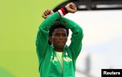 Fayisa Lilesa won the silver medal in the Olympic marathon. He protested Ethiopia's treatment of the Oromo people.