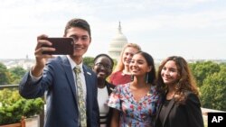 The newly-appointed 2017 Class of National Student Poets, from left, Ben Lee, Juliet Lubwama, Annie Castillo, Kinsale Hueston, and Camila Sanmiguel celebrate with a selfie on the rooftop balcony at the Library of Congress on Thursday, Aug. 31, 2017.