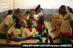 Students learn with the help of a computer tablet provided by UNICEF at a school in Baigai, northern Cameroon, Tuesday 31 October 2017. UNICEF initiated a pilot project in January 2017 called ‘Connect My School’.