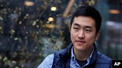 Harvard University graduate Jin K. Park, who holds a degree in molecular and cellular biology, listens during an interview in Cambridge, Mass., Thursday, Dec. 13, 2018. (AP Photo/Charles Krupa)