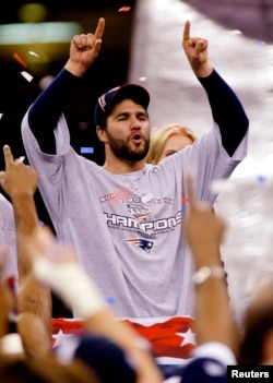 New England Patriots kicker Adam Vinatieri celebrates during postgame ceremonies after the Patriots defeated the St. Louis Rams 20-17 to win Super Bowl XXXVI, in New Orleans on Feb. 3, 2002.