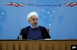 In this photo released by official website of the office of the Iranian Presidency, President Hassan Rouhani attends a meeting with a group of foreign ministry officials in Tehran, Iran, Sunday, July 22, 2018.